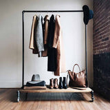 Monroe Trades clothing rack with high end shoes, jackets, and accessories in boutique retail shop
