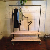 Rolling clothing rack with two wood shelves and top bar