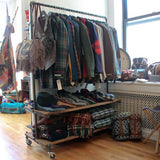Rolling clothing rack in retail shop 
