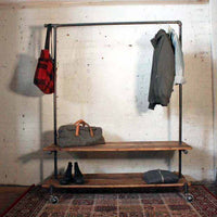 Rolling rack with two wood shelves with mens clothing and shoes