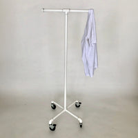 Monroe Trades mobile clothing T shape rack with casters, painted white with a white shirt hanging on it
